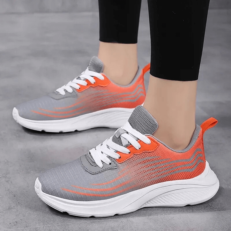Gray and orange women's mesh breathable sneakers for sports, featuring flexible outsole and slip-on closure.